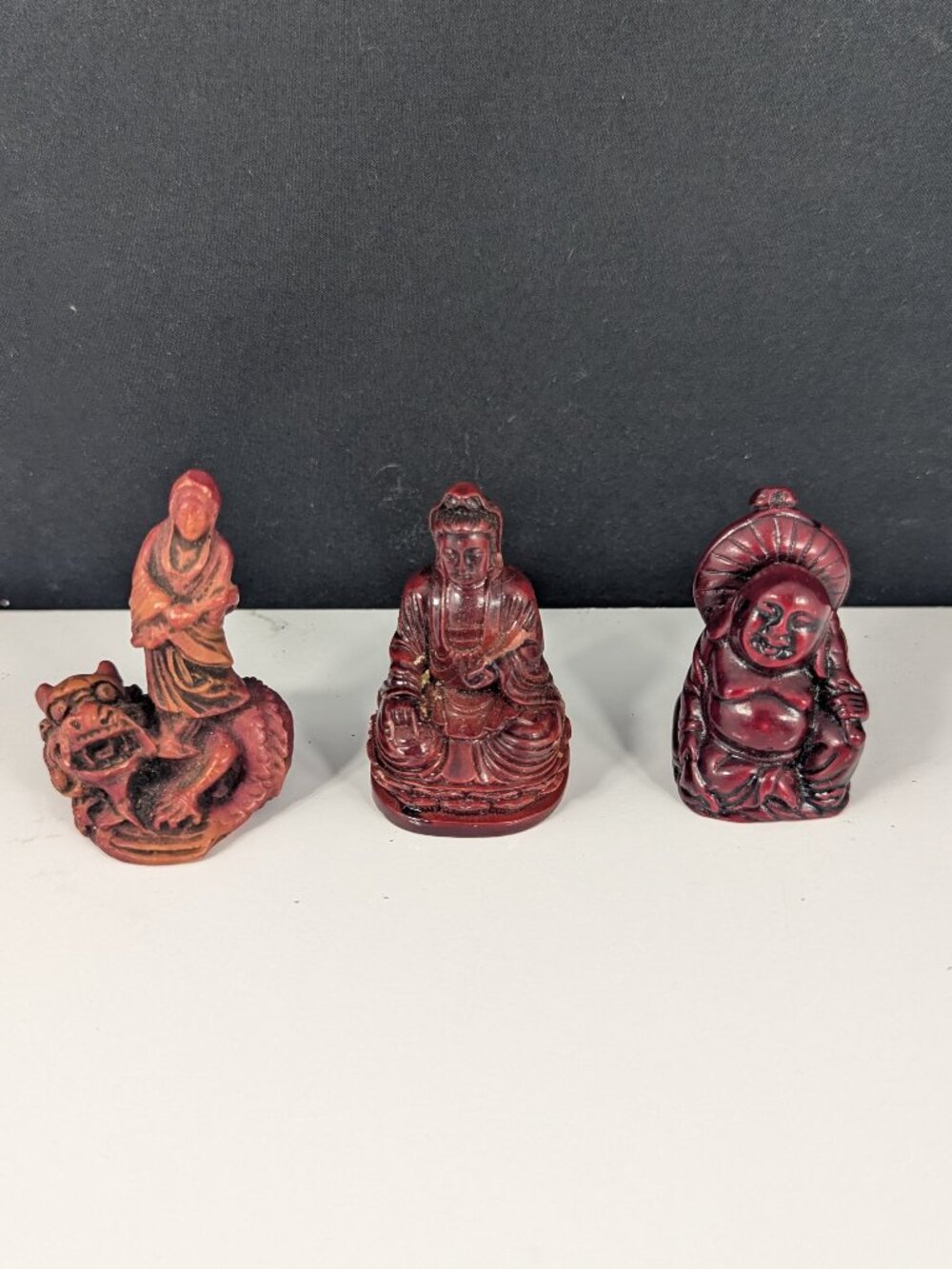 Three red resin Chinese deity statues for good luck